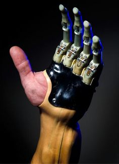 an artificial hand with five fingers is shown in front of a black background