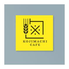 the logo for kojimacchi cafe is shown in black and yellow on a light blue background