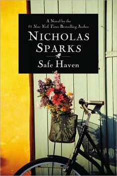 a bicycle parked next to a sign that says nicholas sparks safe haven