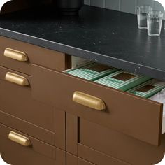 the drawers are open and ready to be filled with files or folders in this kitchen