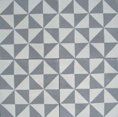 four blue and white tiles with triangles on them