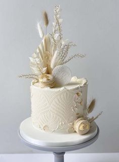 there is a white cake with feathers on it