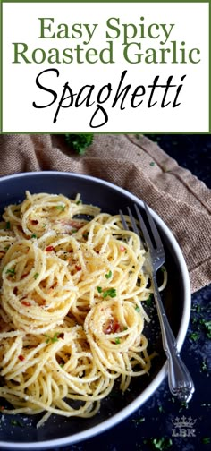 a bowl filled with spaghetti sitting on top of a blue table next to a fork