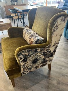 a green chair with flowers on it in a store