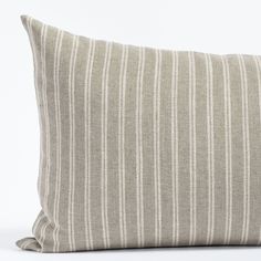 a gray and white striped pillow on a white background with the bottom half turned down