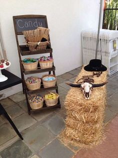 there is a fake cow head on top of hay with other items in the background