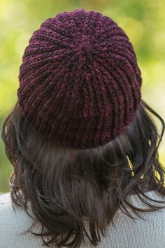 the back of a woman's head wearing a knitted hat