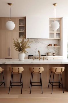 a kitchen with marble counter tops and wooden stools