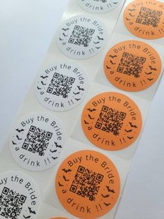 four orange and white stickers with qr - code on them, one for drink