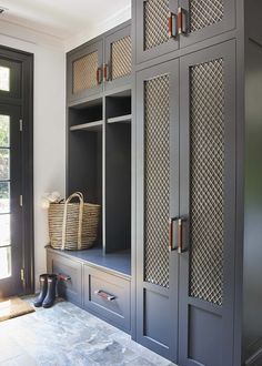 a large gray cabinet with drawers and baskets on it's sides in a room