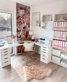 a white desk topped with lots of drawers next to a wall covered in pink flowers