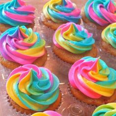 colorful cupcakes with icing being frosted and then decorated to look like rainbow