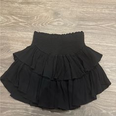 Size Medium Black Ruffle Skirt From Local Boutique-Never Worn Perfect Condition Super Cute Just Doesn't Fit Me Black Fluffy Skirt, Black Pleated Tiered Skort, Black Tiered Pleated Skort, Black Stretch Tiered Skort, Black Tiered Lined Skirt, Black Mini Skort With Elastic Waistband, Black Ruffled Mini Skirt For Night Out, Black Ruffled Skort In Short Length, Black Lined Tiered Skirt