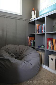 a bean bag chair sitting in front of a bookshelf