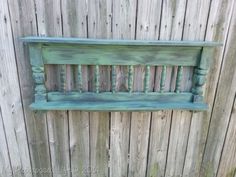 a wooden bench sitting on top of a wooden fence