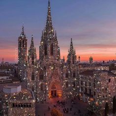 an aerial view of the cathedral in barcelona, spain at night with christmas lights on it