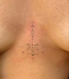 a woman's breast with an intricate design on the chest and back side view