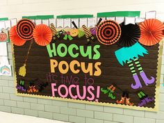 a bulletin board that says hoccus pocus it's time to focus on the wall