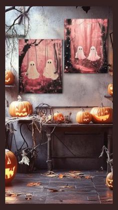 three pumpkins sitting on top of a table next to two pictures with ghost faces