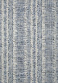 a blue and white rug with vertical stripes on the bottom, in an uneven pattern