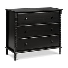 a black dresser with three drawers on it