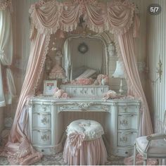 a white dressing table with a mirror and pink curtains