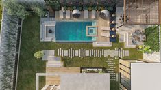 an aerial view of a house with a pool in the yard and decking area