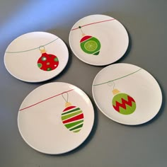 four plates decorated with christmas ornaments on them