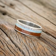 a wooden table with a ring that has been made to look like wood and silver