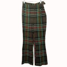 Vintage 1970s Womens Small Brown Plaid Polyester High-Waisted Flared Pants. Step back in time with these vintage 1970s flared pants, featuring a striking plaid pattern in brown with red, yellow, and green accents. These high-waisted pants offer a nostalgic nod to the fashion of the era, ideal for those who love retro styles. (F14) * High-waisted design * Side zipper closure * Brown plaid pattern with red, yellow, green accents * Flared leg * Vintage from the 1970s Seam has come undone on the inner thigh, side zipper in good condition. Waist = 13 inches,  Rise  = 14 inches Inseam = 28 inches Length = 41 inches You are welcome to visit my listings for more great items. Please let me know if you have any other questions. Most Items can be bundled! Brown With Red, High Waisted Flare Pants, Retro Styles, Come Undone, High Waisted Flares, Brown Plaid, Flared Pants, Vintage Pants, Green Accents