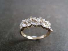 two different views of an engagement ring with diamonds on the side and in the middle