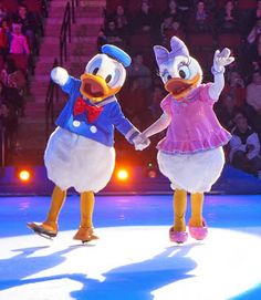 two cartoon characters are dancing on an ice rink