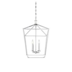 a light fixture hanging from the ceiling with three lights on it and two candles in front of