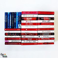 a stack of books sitting on top of each other in front of a white wall