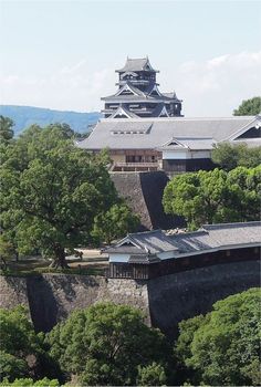 an old castle with trees in the foreground