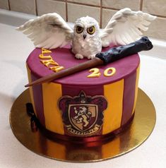 a harry potter birthday cake with an owl and wand