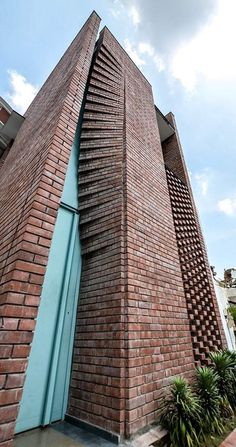 a very tall brick building with a blue door