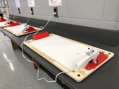 some type of device sitting on top of a table in a room with gray walls