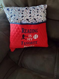 a pillow that reads reading is my favorite sport on the back of a sofa chair