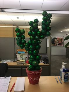 a green balloon cactus in an office cubicle decorated for the new year's eve