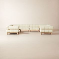 Designed by goop, the Sevigne modular sectional invites low-slung lounging with deep cushioning and a supportive rolled back. Inspired by midcentury Italian modernism with a twist, our version is lifted entirely off the ground by American white oak legs certified sustainable by the Forest Stewardship Council r FSC for a lighter, fresher silhouette. Custom ivory boucle with a performance finish and channel tufting softens the grid of ultra-plush cushions. An unlacquered brass andamp;quot;gandamp; Boucle Sectional, Italian Modernism, Velvet Sectional, Fabric Sectional Sofas, Ceramic Dinnerware Set, Brass Patina, Leather Sectional Sofa, Fabric Sectional, Corner Chair