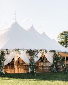 a large white tent set up with tables and chairs