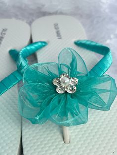 These beautiful white flip flop is hand wrapped in teal green satin ribbon, and adorned with a matching organza flower with pearls and rhinestones in the center. Ribbon color is teal green, if you are needing other colors of ribbon or decoration please contact me and will be happy to accommodate you! All flip flops are handmade to order and the production time is 5-7 business days and then please allow additional time for shipping. Amazing for beach, weddings, flower girl or a fancy event, you c Beach Wedding Sandals, Wedding Flip Flops, Fancy Event, Sandals Wedding, White Flip Flops, Organza Flowers, Bridal Sandals, Sandals Beach, Wedding Sandals