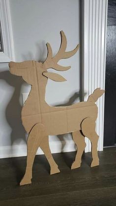 a cardboard deer standing next to a door