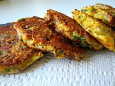 four fritters are stacked on top of each other, ready to be eaten