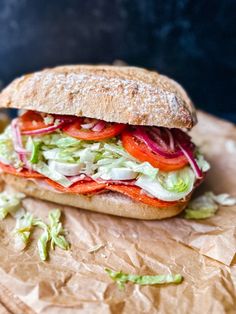 a sandwich with lettuce, tomato and onion