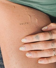 a woman's legs with flowers on them and the word salty written in small letters