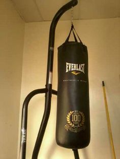 a black punching bag hanging from the side of a wall