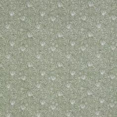 a green wallpaper with white leaves on it