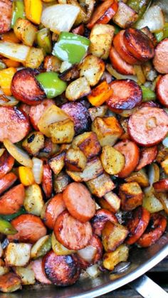 a pan filled with cooked vegetables on top of a wooden table